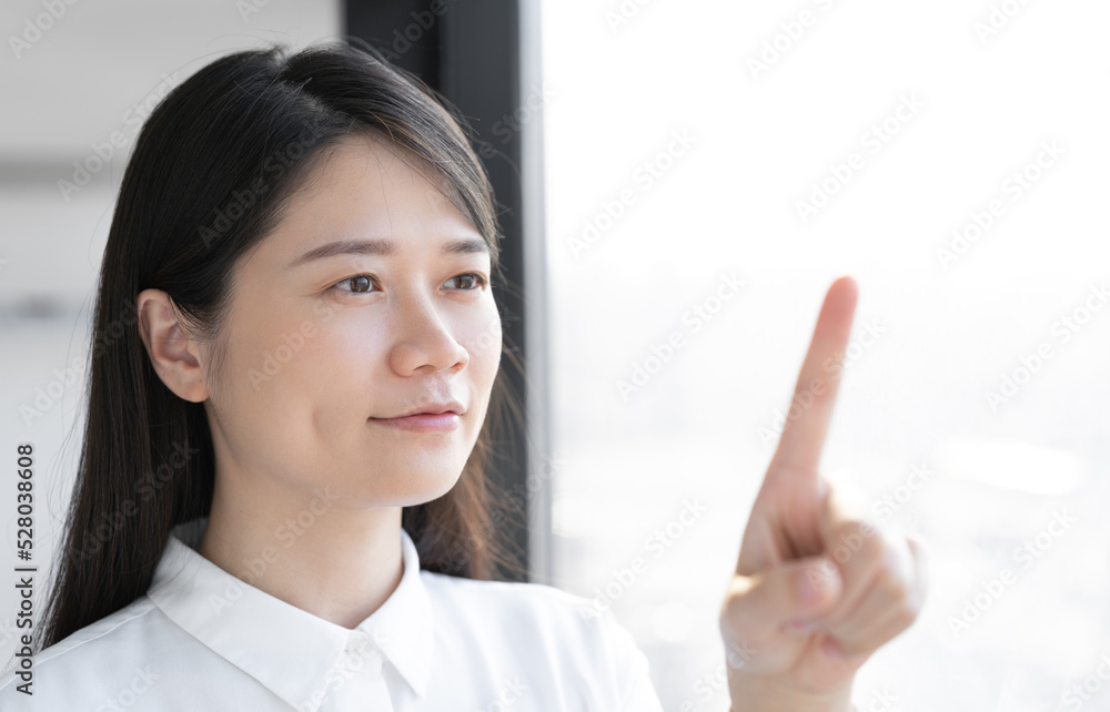 woman look at window and pointing on something woman look at window and pointing on something