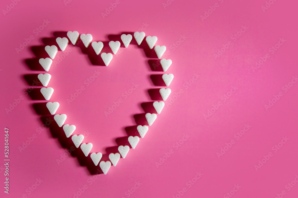 Heart made of sugar cube hearts on pink background Heart made of sugar cube hearts on pink background