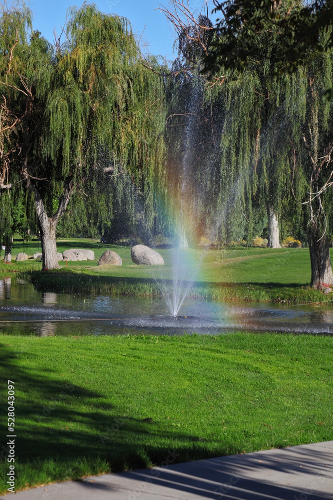 The fountain and  rainbow on the golf course