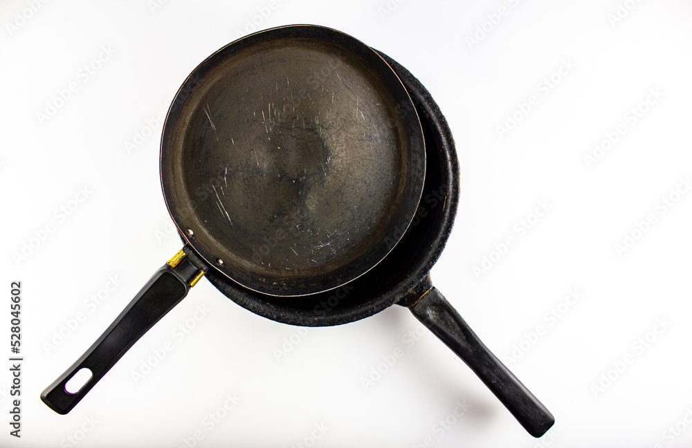 Dirty frying pans, dishes on a white background. Washing utensils. Dirty frying pans, dishes on a white background. Washing utensils.