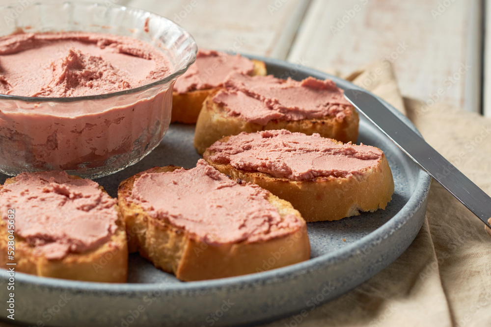 Bread toast with pork liver pâté on a rustic background. Bread toast with pork liver pâté on a rustic background.
