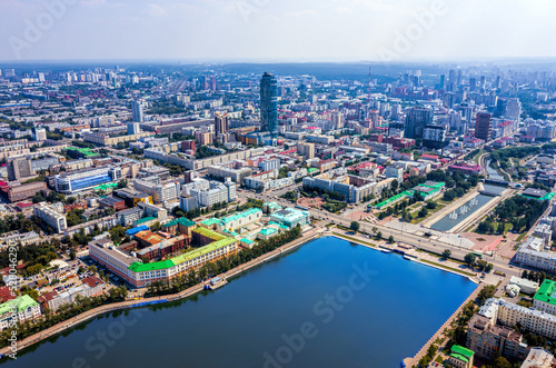 Aerial view of central part of modern city with skyscrapers and residential buildings. River and bridge on summer day. © ArtEvent ET
