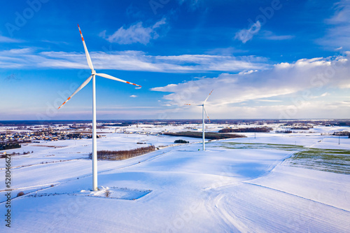 Alternative energy at winter. Snowy field and wind turbine.