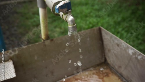 high angle view footage of gurgling water from a slightly open faucet photo