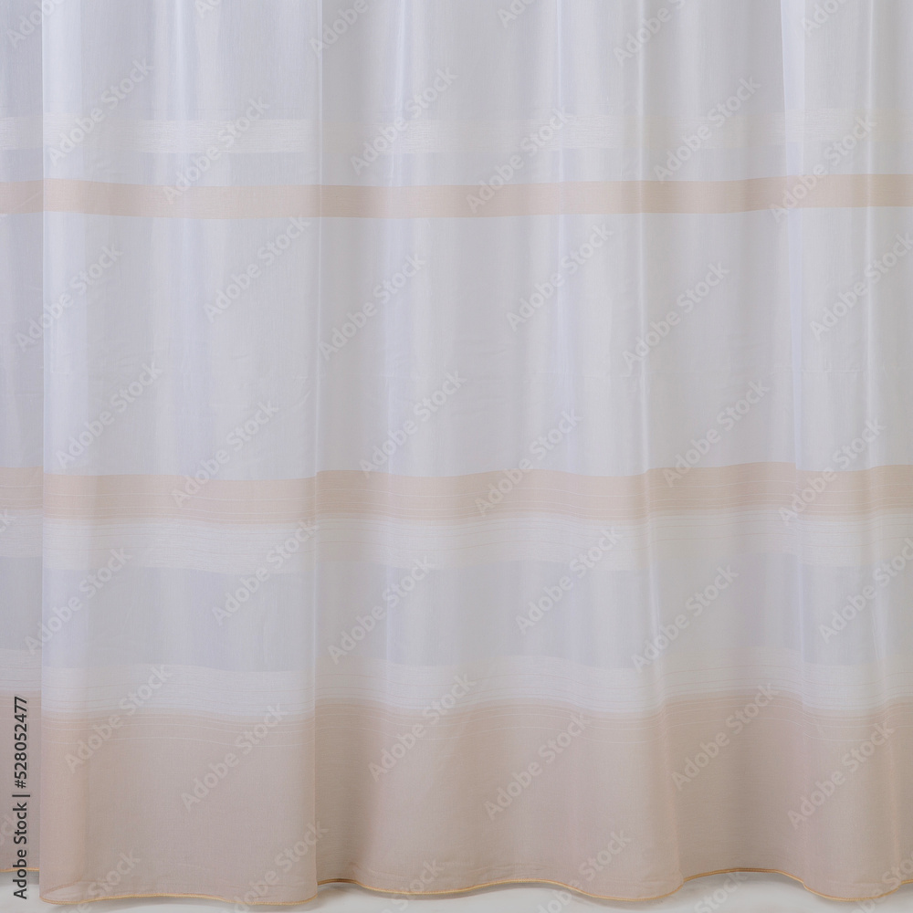 Tulle texture with folds, hanging straight, beige stripes on the fabric Tulle texture with folds, hanging straight, beige stripes on the fabric