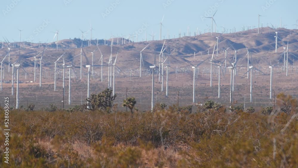 Windmills turbine rotating, wind farm or power plant, alternative green renewable energy generators, industrial field in California, Mojave desert, Tehachapi, USA. Electricity generation on windfarm. Windmills turbine rotating, wind farm or power plant, alternative green renewable energy generators, industrial field in California, Mojave desert, Tehachapi, USA. Electricity generation on windfarm.