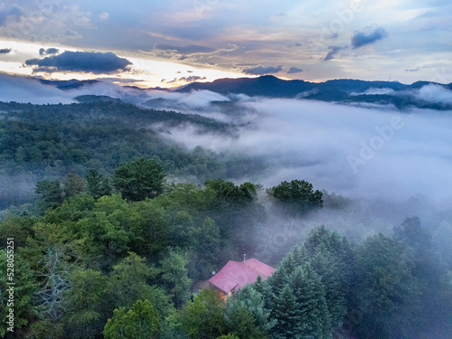 Gorgeous sunrise over the Appalachian mountain with fog surrounding it below and a blue and pink sky