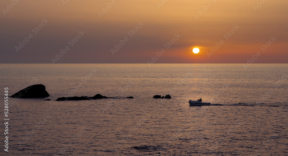 sunset over the sea with rocks in Ischia Forio