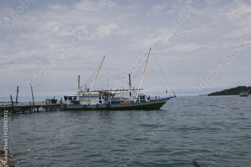 Fishing boat leaning on the pier