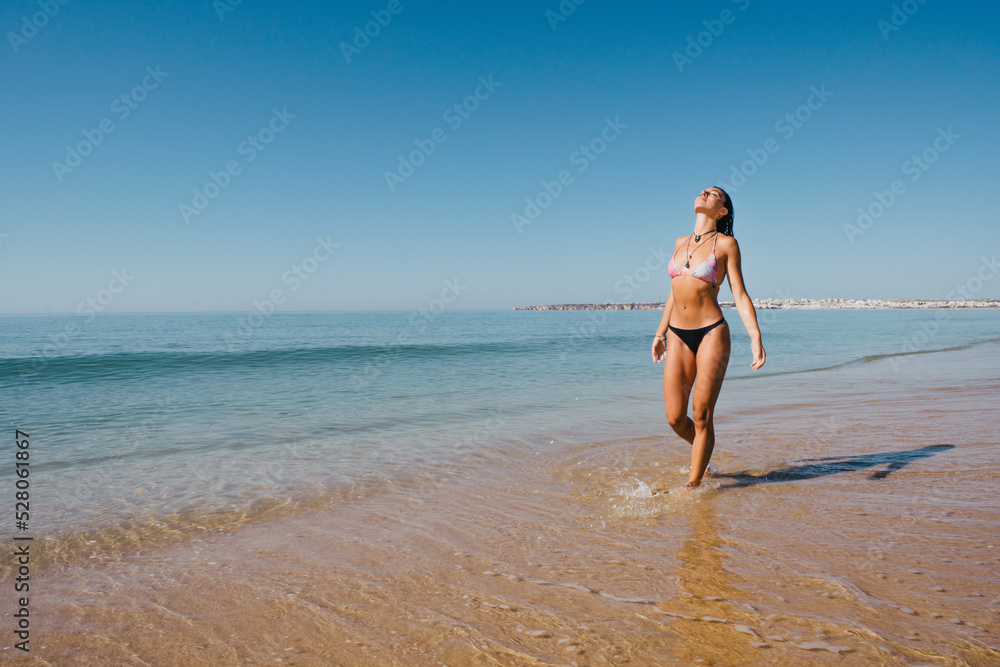 BEAUTIFUL GIRL WALKING AND ENJOYING THE SUN AND THE BEACH ON HER VACATION AND GETTING INTO THE OCEAN AND VERY HAPPY AMD SMILLING BEAUTIFUL GIRL WALKING AND ENJOYING THE SUN AND THE BEACH ON HER VACATION AND GETTING INTO THE OCEAN AND VERY HAPPY AMD SMILLING