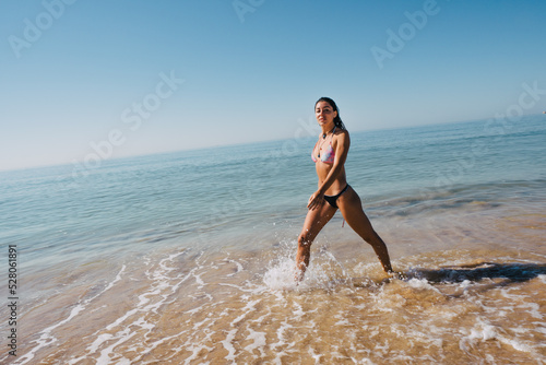 BEAUTIFUL GIRL WALKING AND ENJOYING THE SUN AND THE BEACH ON VACATION