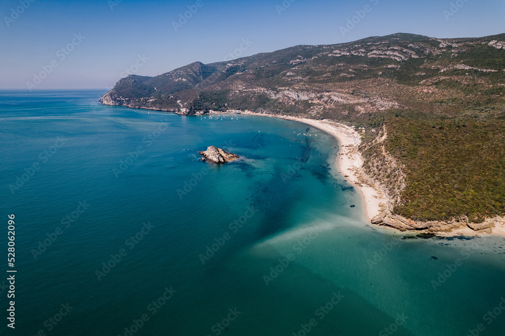 drone photo with sunny beach with people and a big blue ocean and clear sky. A perfect nature holiday day at the sea with boats and trees