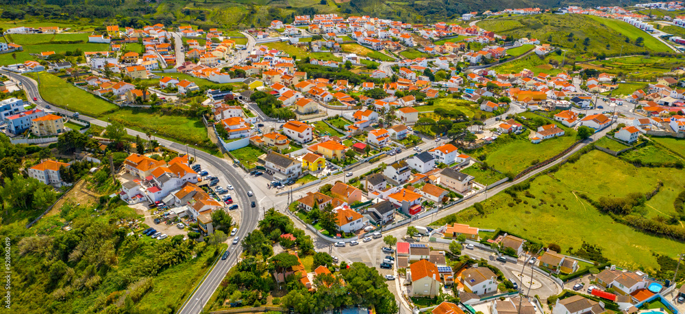 Small European city in a green valley with a blue sky.  Aerial view of the scenic city landscape on a sunny summer day.  Beautiful city landscape with a horizon line. Portugal tourist region in summer