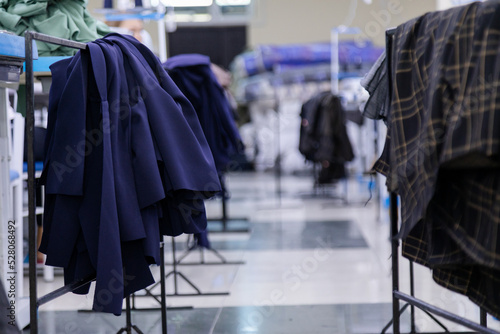 New clothes hanging on a stand in sewing factory