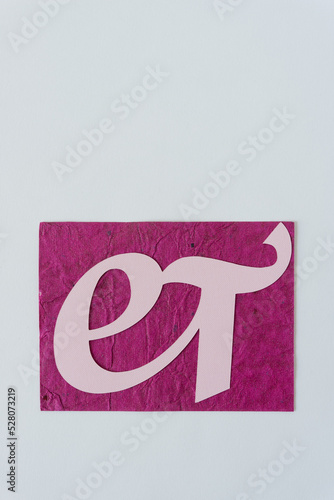 logogram et in pink on blank paper photo