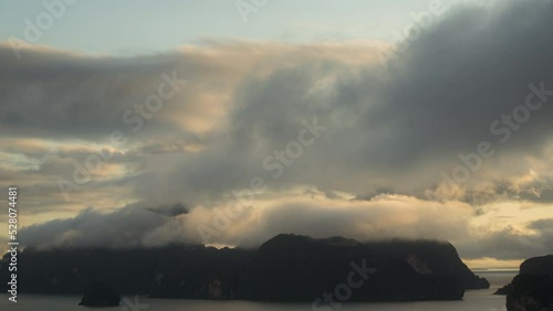 timelapse of clouds and sunlight moving over smed nangshe phang-nga ,thailand during a summer morning photo