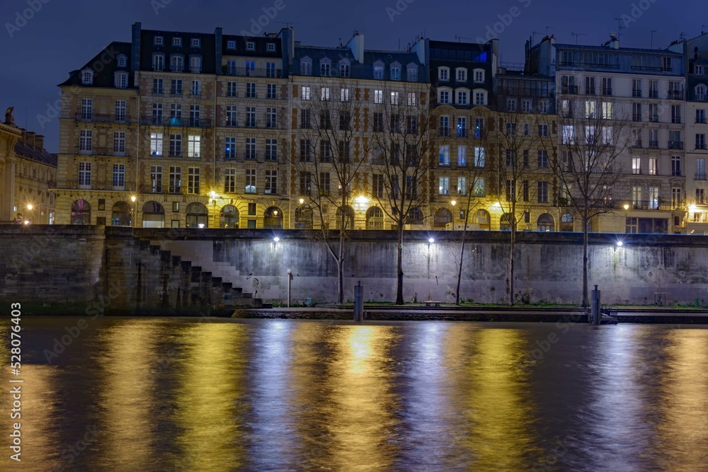 the Seine Rive in Paris at night with city light and buildings the Seine Rive in Paris at night with city light and buildings