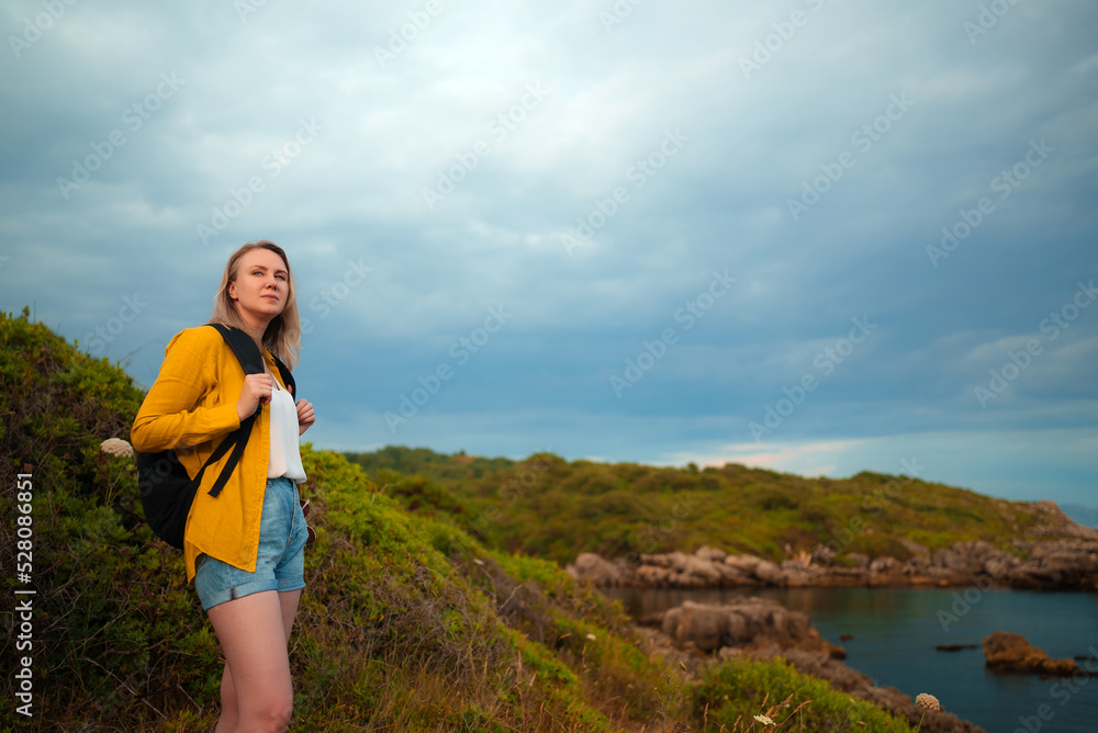 Woman tourist with backpack visits nature reserve in Italy. Woman tourist with backpack visits nature reserve in Italy.