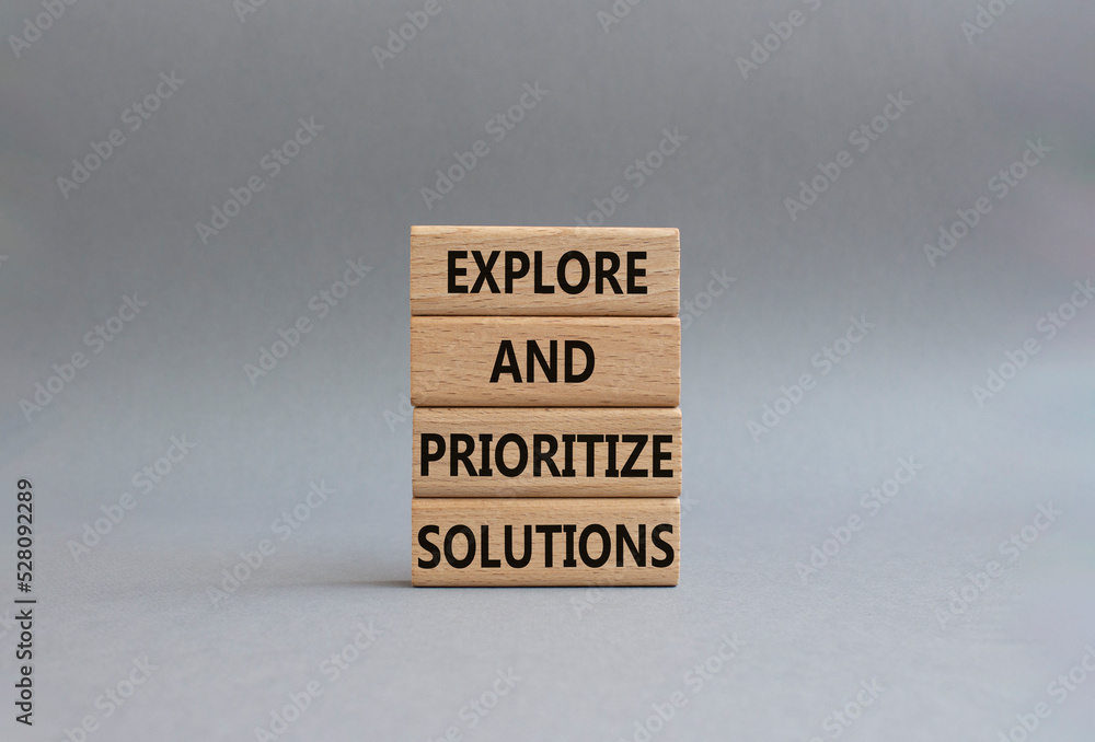 Solution symbol. Wooden blocks with words Explore and prioritize solutions. Beautiful grey background. Business and solution concept. Copy space. Solution symbol. Wooden blocks with words Explore and prioritize solutions. Beautiful grey background. Business and solution concept. Copy space.