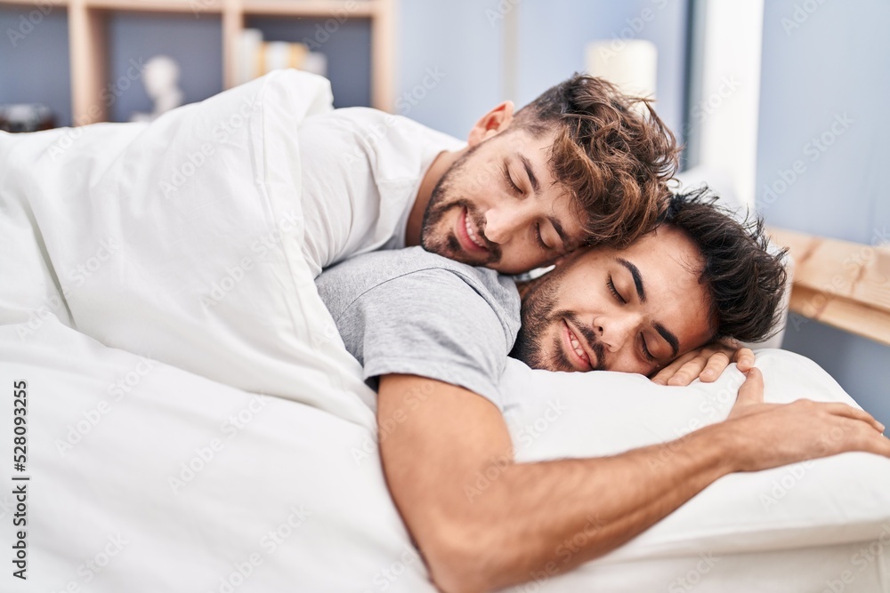 Young couple hugging each other lying on bed at bedrooom Young couple hugging each other lying on bed at bedrooom