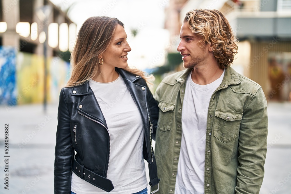 Man and woman couple smiling confident standing together at street Man and woman couple smiling confident standing together at street