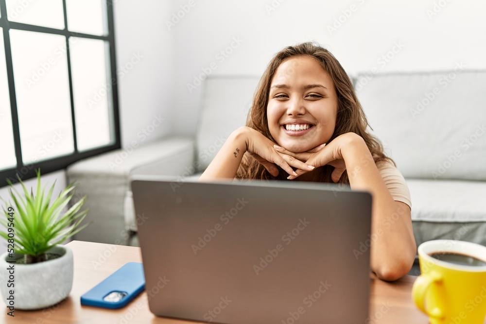 Young beautiful hispanic woman using laptop sitting on floor at home Young beautiful hispanic woman using laptop sitting on floor at home