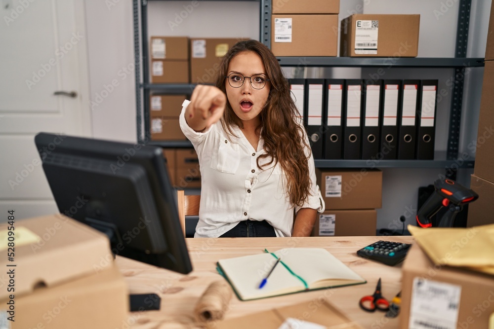 Young hispanic woman working at small business ecommerce pointing displeased and frustrated to the camera, angry and furious with you Young hispanic woman working at small business ecommerce pointing displeased and frustrated to the camera, angry and furious with you