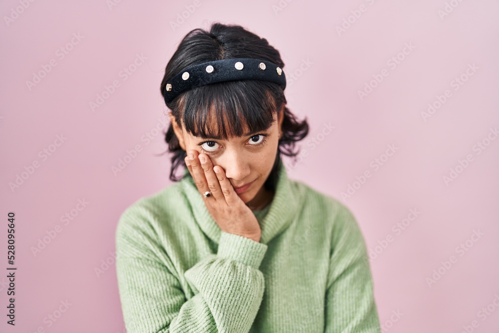Young beautiful woman standing over pink background thinking looking tired and bored with depression problems with crossed arms. Young beautiful woman standing over pink background thinking looking tired and bored with depression problems with crossed arms.