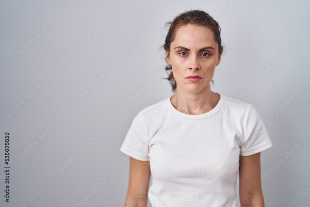 Beautiful brunette woman standing over isolated background skeptic and nervous, frowning upset because of problem. negative person. Beautiful brunette woman standing over isolated background skeptic and nervous, frowning upset because of problem. negative person.