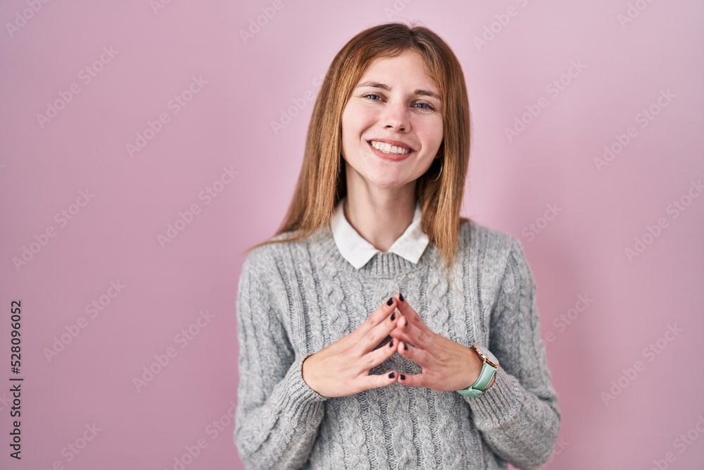 Beautiful woman standing over pink background hands together and fingers crossed smiling relaxed and cheerful. success and optimistic Beautiful woman standing over pink background hands together and fingers crossed smiling relaxed and cheerful. success and optimistic