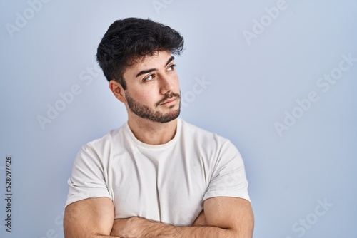 Wallpaper Mural Hispanic man with beard standing over white background looking to the side with arms crossed convinced and confident Torontodigital.ca