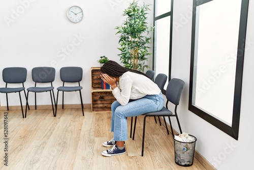 Young african american woman desperate sitting on chair at waiting room © Krakenimages.com