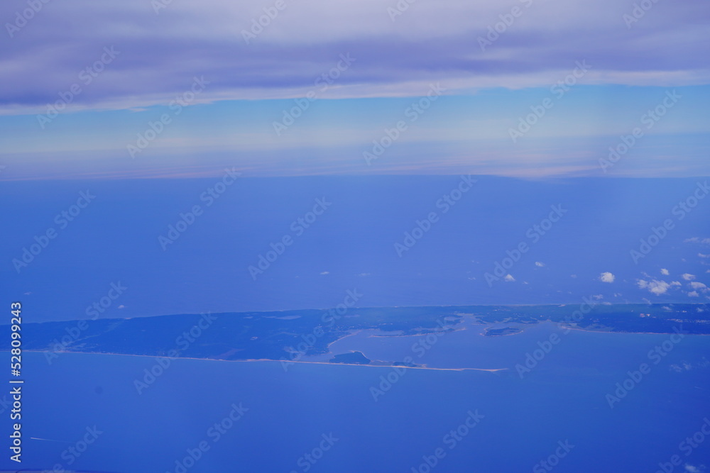 an aerial view of Cape Cod, city view and beach and ocean view from airplane. Cape Cod, a hook-shaped peninsula of the U.S. state of Massachusetts, is a popular summertime destination.