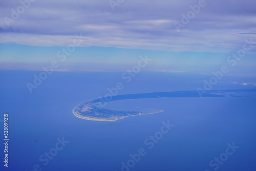 an aerial view of Cape Cod, city view and beach and ocean view from airplane. Cape Cod, a hook-shaped peninsula of the U.S. state of Massachusetts, is a popular summertime destination.