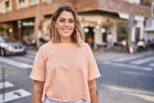 Young hispanic woman smiling confident at street