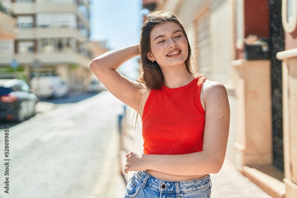 Young caucasian woman smiling confident looking to the side at street