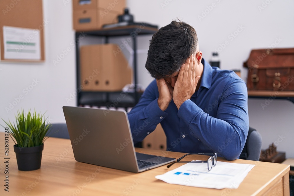 Young hispanic man business worker stressed using laptop at office Young hispanic man business worker stressed using laptop at office