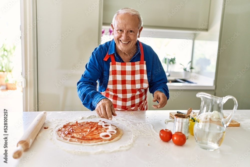 Senior man smiling confident cooking pizza at kitchen Senior man smiling confident cooking pizza at kitchen