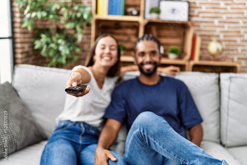 Man and woman couple smiling confident watching tv at home
