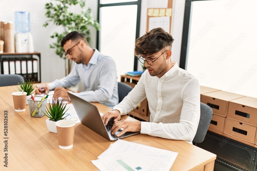 Two hispanic men business workers concentrate working at office