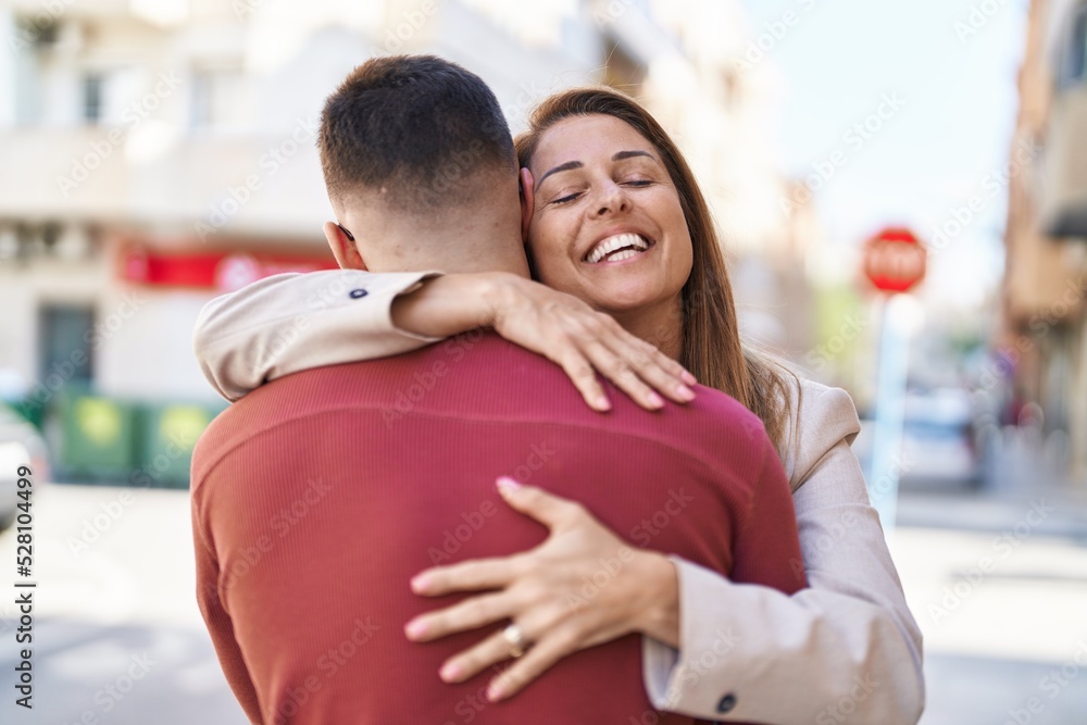 Man and woman mother and son hugging each other at street Man and woman mother and son hugging each other at street