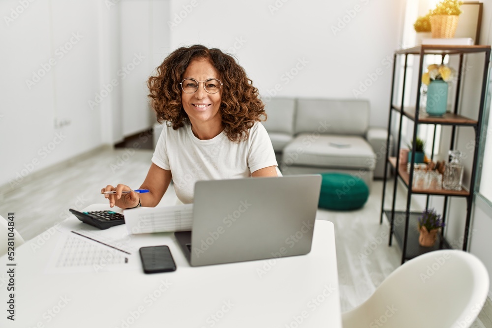 Middle age hispanic woman smiling confident working at home Middle age hispanic woman smiling confident working at home