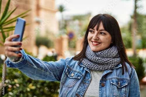 Wallpaper Mural Young brunette woman smiling taking a selfie picture at the city Torontodigital.ca