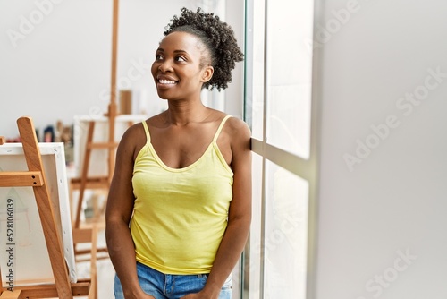 Young african american artist woman smiling happy standing at art studio.