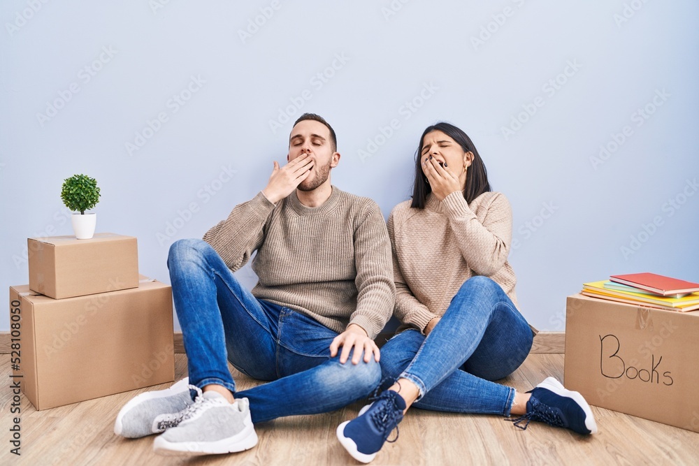 Young couple moving to a new home bored yawning tired covering mouth with hand. restless and sleepiness. Young couple moving to a new home bored yawning tired covering mouth with hand. restless and sleepiness.