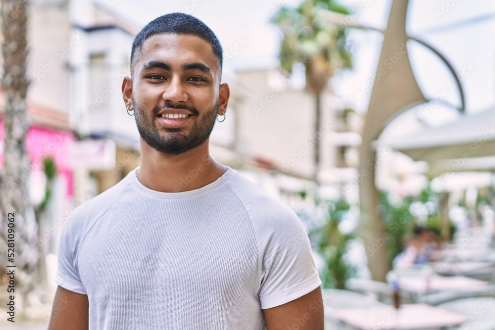 Young middle east man smiling happy standing at the city. Young middle east man smiling happy standing at the city.