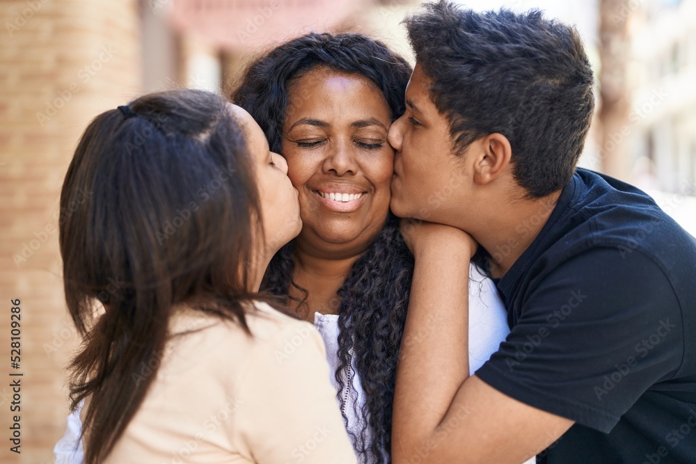 African american family hugging each other kissing at street African american family hugging each other kissing at street