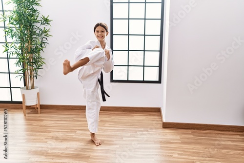 Young hispanic girl doing martial arts at training studio