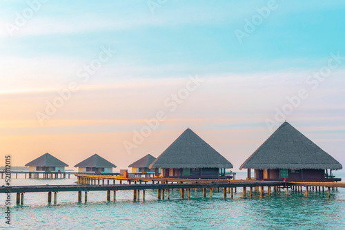 view of the water villas at sunrise in the Maldives  the concept of luxury travel