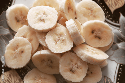 Chopped bananas in plate . Healthy exotic fruit 